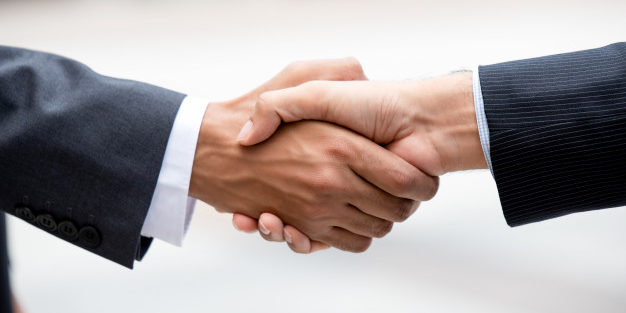 Business partners Making Firm Handshake| Legal Advice Guru