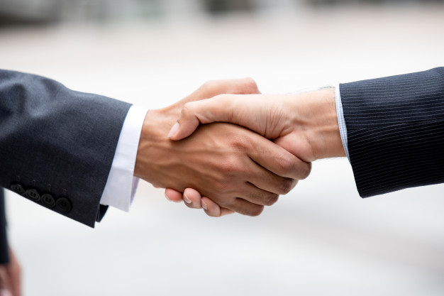 Business partners Making Firm Handshake| Legal Advice Guru