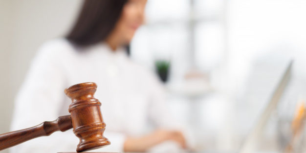 wooden gavel table attorney working court | Legal Advice Guru