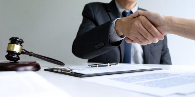 lawyer judge with gavel giving handshake | Legal Advice Guru