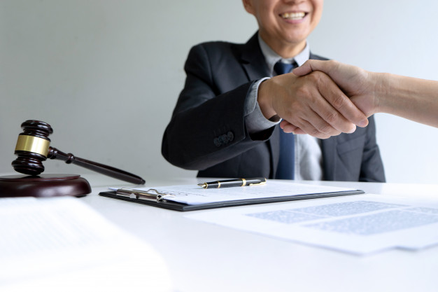 lawyer judge with gavel giving handshake | Legal Advice Guru